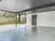 This covered carport features a modern paint scheme, backyard access, and an attached storage shed at 4202 W Bay Vista Ave, Tampa, FL 33611