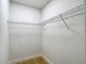 Walk-in closet featuring new wood-style floor and wire shelving at 4202 W Bay Vista Ave, Tampa, FL 33611