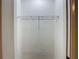 A large empty closet with a metal rack and white walls at 4202 W Bay Vista Ave, Tampa, FL 33611