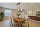 Bright dining room featuring a modern light fixture, wood table set, and an open floor plan at 4202 W Bay Vista Ave, Tampa, FL 33611