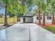 Charming exterior with mature palm trees, freshly painted facade, and a convenient carport at 4202 W Bay Vista Ave, Tampa, FL 33611