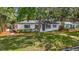 Cozy home featuring a well-maintained lawn and mature landscaping, great curb appeal at 4202 W Bay Vista Ave, Tampa, FL 33611