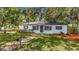 Charming home featuring a manicured lawn, fresh mulch, and inviting brick pathway at 4202 W Bay Vista Ave, Tampa, FL 33611