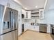 Modern kitchen featuring stainless steel appliances, white cabinetry and light granite countertops at 4202 W Bay Vista Ave, Tampa, FL 33611