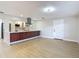 Bright kitchen with stainless steel appliances, a breakfast bar, and modern gray backsplash at 4202 W Bay Vista Ave, Tampa, FL 33611