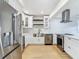 Bright kitchen with stainless steel appliances, custom cabinetry and light granite countertops at 4202 W Bay Vista Ave, Tampa, FL 33611