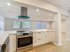 Bright kitchen with stainless steel appliances, large island, and recessed lighting at 4202 W Bay Vista Ave, Tampa, FL 33611