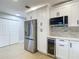 Updated kitchen showcasing stainless steel appliances and white cabinets at 4202 W Bay Vista Ave, Tampa, FL 33611