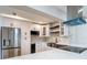 This renovated kitchen features stainless steel appliances, white cabinets, and a farmhouse sink at 4202 W Bay Vista Ave, Tampa, FL 33611
