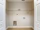 Utility room with washer hook-up, shelving and hardwood floors at 4202 W Bay Vista Ave, Tampa, FL 33611