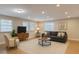 Cozy living room featuring modern furniture, recessed lighting, and a neutral color palette at 4202 W Bay Vista Ave, Tampa, FL 33611