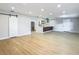 Open-concept living area features new floors, a sliding barn door, and adjacent kitchen at 4202 W Bay Vista Ave, Tampa, FL 33611