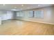 A spacious, light-filled living room featuring large windows and sleek, modern flooring at 4202 W Bay Vista Ave, Tampa, FL 33611