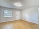 Bright living room with wood flooring, contemporary light fixtures and neutral paint at 4202 W Bay Vista Ave, Tampa, FL 33611
