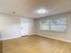 Bright living room featuring wood flooring, a neutral color palette, and natural light at 4202 W Bay Vista Ave, Tampa, FL 33611