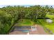 Aerial view showing the property's boundaries, landscaping, pool, and proximity to surrounding greenery at 4401 W Sam Allen Rd, Plant City, FL 33565