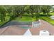 Aerial view featuring the home, pool, backyard, and surrounding trees at 4401 W Sam Allen Rd, Plant City, FL 33565