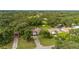 Wide aerial shot of the property showing lush greenery, surrounding trees and neighborhood at 4401 W Sam Allen Rd, Plant City, FL 33565