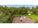 Aerial view of the property featuring a spacious backyard, mature trees, and a screened pool area at 4401 W Sam Allen Rd, Plant City, FL 33565