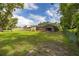 Expansive backyard featuring large trees, an open lawn, and a screened patio at 4401 W Sam Allen Rd, Plant City, FL 33565