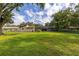 Expansive backyard featuring large trees, an open lawn, and a screened patio at 4401 W Sam Allen Rd, Plant City, FL 33565