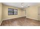 Bedroom featuring wood-look floors, closet and ceiling fan at 4401 W Sam Allen Rd, Plant City, FL 33565