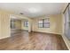 Bedroom featuring wood-look floors, mirrored closet and large windows at 4401 W Sam Allen Rd, Plant City, FL 33565