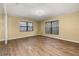 Bedroom with wood-look floors, a ceiling fan and large windows at 4401 W Sam Allen Rd, Plant City, FL 33565