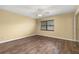 A comfortable bedroom featuring wood-look flooring, a ceiling fan, and a bright window at 4401 W Sam Allen Rd, Plant City, FL 33565