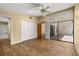 Bedroom features wood floors, a ceiling fan, closet, and access to bath and backyard at 4401 W Sam Allen Rd, Plant City, FL 33565