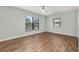 A bright bedroom offers ample natural light, wood-look floors, and neutral paint at 4401 W Sam Allen Rd, Plant City, FL 33565