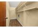 Walk-in closet with wood floors and built in shelving at 4401 W Sam Allen Rd, Plant City, FL 33565
