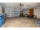 Garage with open storage, lawn equipment, and rolling garage door at 4401 W Sam Allen Rd, Plant City, FL 33565