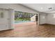 Bright living room featuring hard surface floors and direct access to the pool at 4401 W Sam Allen Rd, Plant City, FL 33565
