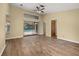 Open living room featuring wood flooring and a sliding glass door leading to the pool at 4401 W Sam Allen Rd, Plant City, FL 33565