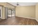 Neutral living room with light yellow walls, wood floors, sliding glass doors, and ceiling fan at 4401 W Sam Allen Rd, Plant City, FL 33565