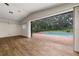 A large living room is equipped with hard surface floors and direct access to the pool at 4401 W Sam Allen Rd, Plant City, FL 33565
