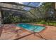 Screened in pool area with red brick pavers and mature landscaping at 4401 W Sam Allen Rd, Plant City, FL 33565