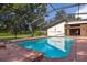 Screened in pool, hot tub, and patio with views of the expansive lawn at 4401 W Sam Allen Rd, Plant City, FL 33565