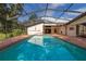 Enclosed pool with brick deck featuring backyard views and a spacious enclosure at 4401 W Sam Allen Rd, Plant City, FL 33565