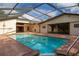 Enclosed pool featuring a brick deck, a built-in hot tub, and a bright enclosure at 4401 W Sam Allen Rd, Plant City, FL 33565