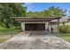 The large two-car carport features a brick paver drive leading up to it at 4401 W Sam Allen Rd, Plant City, FL 33565