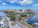 Panoramic aerial view of waterfront condos, boat docks, tennis courts, and lush landscaping at 6009 Sea Ranch Dr # 203, Hudson, FL 34667