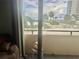 Balcony view capturing serene waterfront views, palm trees, and inviting outdoor seating at 6009 Sea Ranch Dr # 203, Hudson, FL 34667