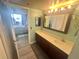 Bathroom featuring a vanity with ample counter space, a mirror and open access to a bedroom at 6009 Sea Ranch Dr # 203, Hudson, FL 34667
