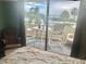 Cozy bedroom with balcony featuring a seating area and tranquil water views at 6009 Sea Ranch Dr # 203, Hudson, FL 34667