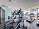 Well-equipped fitness center with treadmills, ellipticals, and scenic views of the water at 6009 Sea Ranch Dr # 203, Hudson, FL 34667