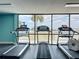 Fitness center with a row of treadmills, offering water views for an invigorating workout experience at 6009 Sea Ranch Dr # 203, Hudson, FL 34667
