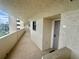 Exterior shot of a clean, well-lit condominium hallway with neutral paint and tile flooring at 6009 Sea Ranch Dr # 203, Hudson, FL 34667