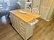Kitchen island with butcher block top, storage, and breakfast bar seating area at 6009 Sea Ranch Dr # 203, Hudson, FL 34667